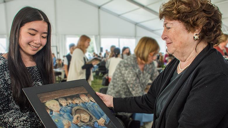 student shares artwork with Holocaust survivor